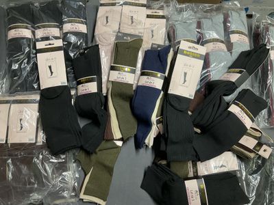 several pairs of men ' s socks are wrapped in plastic