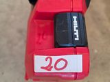 a close up of a red cordless drill with a number on it