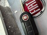 a close up of a car key and a keychain on a table