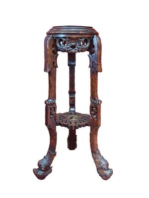 a wooden table with a carved top on a white background