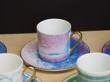 four cups and saucers sitting on a table