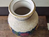 a small vase sitting on top of a wooden table