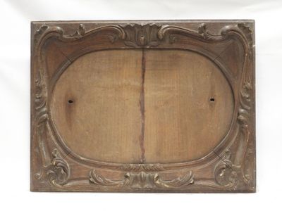 an old wooden picture frame with a decorative design on it