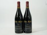 two bottles of wine sitting next to each other on a table