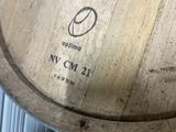 a close up of a wooden barrel with a logo on it