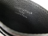 a close up of a black shoe with a white background