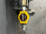 a close up of a yellow and black valve on a wall