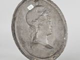 an old silver coin with a woman ' s face on it