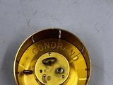 a close up of a clock that is on a table