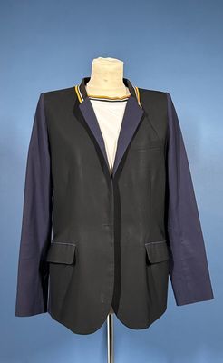 jacket on a mannequin stand against a blue background