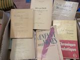 many books that are in a box on the floor