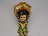 a ceramic figurine of a woman with a basket on her head