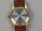 a close up of a wrist watch with a brown strap