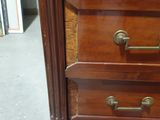 an image of a wooden dresser with three drawers