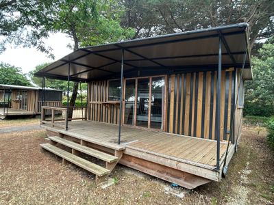 a small wooden cabin with a porch and a covered porch
