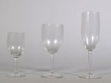 three empty wine glasses sitting next to each other on a table
