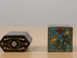 two small boxes that are sitting on a table
