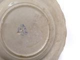 a white plate with a bird on it on a white surface
