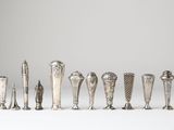a group of silver objects sitting on top of a white surface