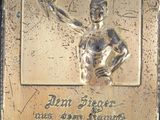 a plaque of a man holding a tennis racquet