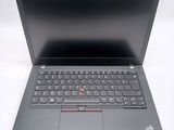 the laptop is open on a white surface with a black keyboard