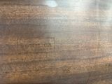 a close up of a wooden table with a clock on it
