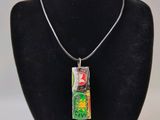 a necklace with a picture on it on a mannequin