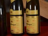 three bottles of wine sitting on a table next to each other