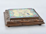 a small wooden box with a floral design on it