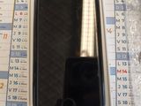 a black cell phone sitting on top of a calendar