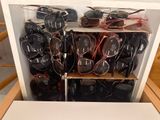 many pairs of sunglasses sitting on a shelf in a box