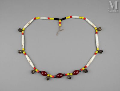 un gros plan d'un collier posé sur une surface grise