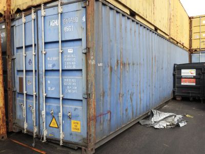 a large blue container sitting in the middle of a parking lot