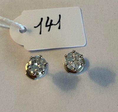 pair of diamond stud earrings with price tag on white background