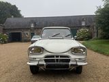 a white car that is parked in front of a house