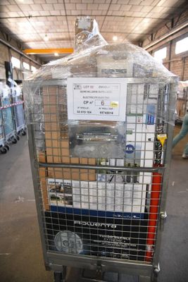 a metal cart with a sign on it in a warehouse