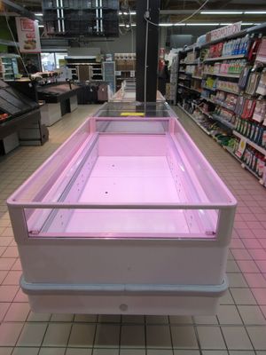 a pink display case in the middle of a grocery store