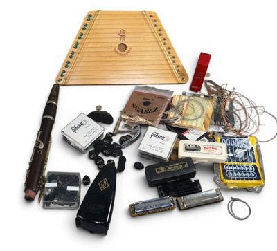 an image of a variety of musical instruments and accessories laid out on a white surface