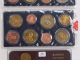 a close up of a bunch of different colored coins on a table
