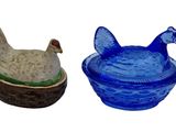 two small glass bowls with animals in them on a white background