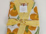 a yellow and white towel wrapped in yellow and green fabric