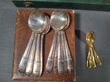 four spoons and two spoons sitting on a box