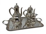 a silver tray with a silver tea set on it