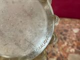 a close up of a glass vase on a marble table
