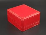 a small red box on a table with a black background