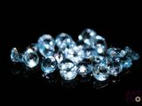 some very pretty blue diamonds on a black surface