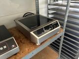 two stoves on a shelf in a kitchen
