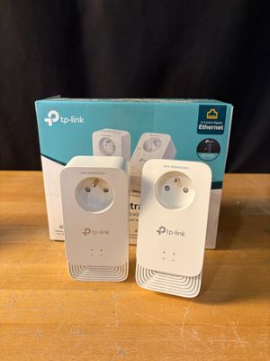 three tp - link tl - wpa230n powerline wi - fi extendr plugs on a table next to a box
