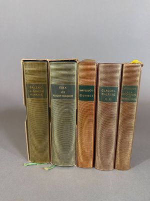 four books are lined up in a row on a table