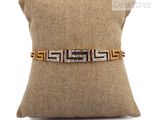 a close up of a pillow with a gold and silver bracelet on it